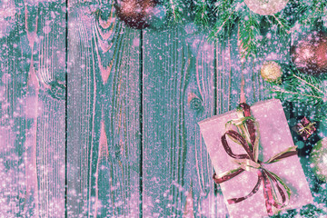 Christmas gift boxes and fir tree  on wooden background.