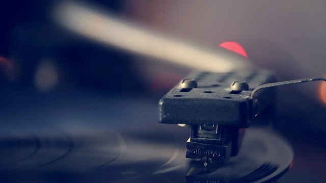 Extremely close-up of antiquarian record player with the needle playing record album on a vintage turntable, vinyl record spinning, selective focus