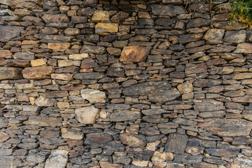 .Beautiful wall made of wild stone. Natural background.
