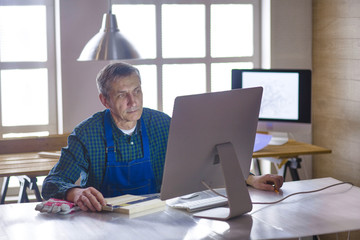 Engineer carpenter working on laptop and sketching project