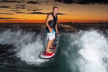 Man surfing at sunset.
