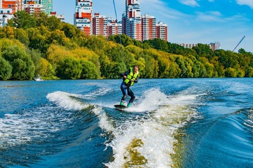 A man riding wakeboard in the river