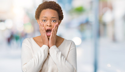 Young african american woman over isolated background afraid and shocked with surprise expression,...