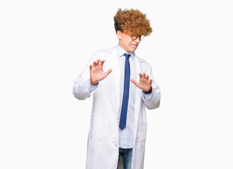 Young handsome scientist man wearing glasses disgusted expression, displeased and fearful doing...