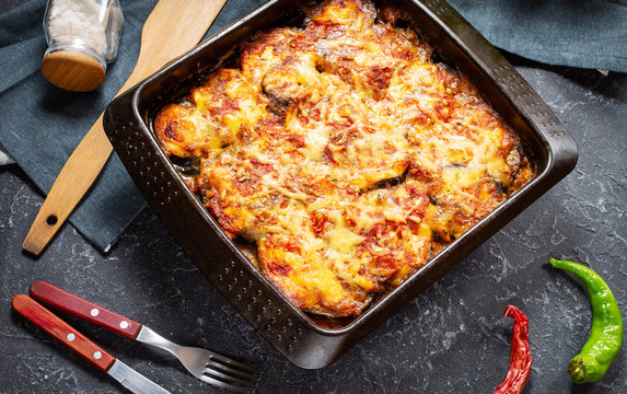 Baked eggplant with cheese on a stone table. Parmigiana melanzane. Italian cuisine.