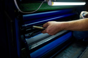 The master have service an industrial offset printing press machine. The process of tuning the...