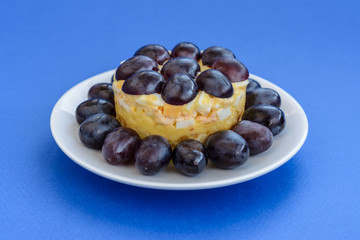 The legendary Tiffany layered salad with grapes, chicken and cheese on the blue background.