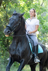 Obraz premium riding girl and horse