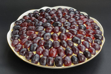 The legendary Tiffany layered salad with grapes, chicken and cheese on the black background.