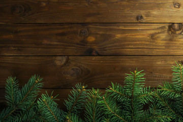 Fir tree twigs on wooden background. Christmas concept