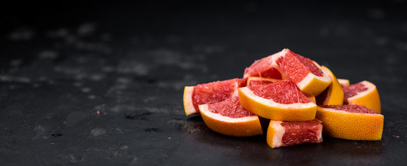Sliced Grapefruits on a slate slab (selective focus)