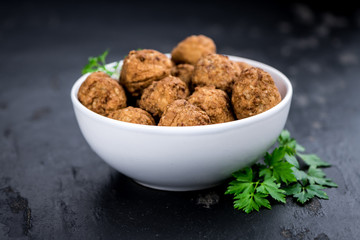 Meatballs on a vintage looking slate slab (selective focus)