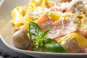 Ravioli pasta with cream, mushrooms and ham