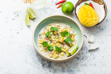 Raw scallops appetizer with mango, coconut and pineapple
