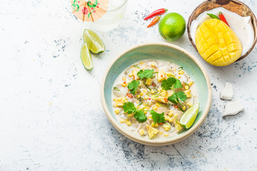 Scallops ceviche with mango and pineapple in coconut milk, thai style, copy space
