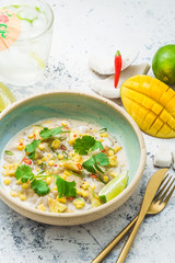 Scallops tartare with mango and pineapple in coconut milk, thai style, copy space