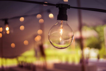 Image of glowing light bulb on dark background