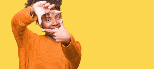 Beautiful young african american woman over isolated background smiling making frame with hands and...