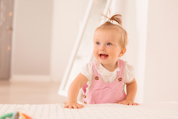 baby girl in the nursery playing,bright children's room, textiles for children's room