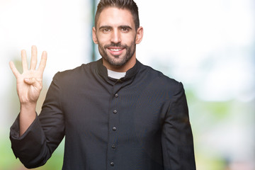Young Christian priest over isolated background showing and pointing up with fingers number four...