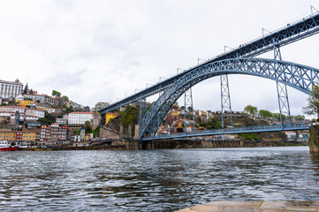 Fototapeta na wymiar Douro river in Porto. The dominants of the city are the Dom Luis I Bridge