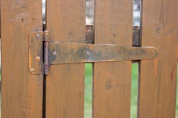 brown painted wooden fence and metal loop