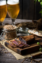 Fototapeta na wymiar Beer still life with fishes and bottles. Meat basturma. October fest. Oktoberfest. Dry fish and dry meat. Country meal