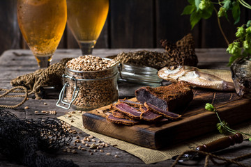 Beer still life with fishes and bottles. Meat basturma. October fest. Oktoberfest. Dry fish and dry meat. Country meal