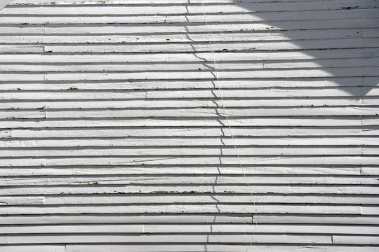 detail of a wall with white wood siding