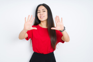 Beautiful brunette woman wearing red t-shirt over isolated background Smiling doing frame using hands palms and fingers, camera perspective