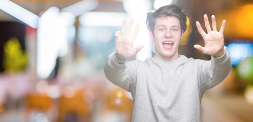 Young handsome sporty man wearing sweatshirt over isolated background showing and pointing up with...