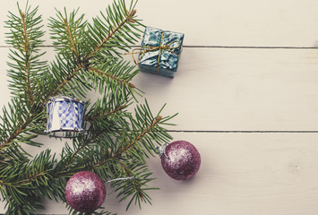 Christmas decoration baubles with branches of fir tree on wooden background