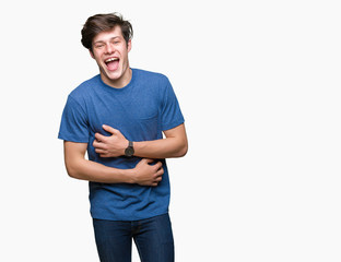 Young handsome man wearing blue t-shirt over isolated background Smiling and laughing hard out loud because funny crazy joke. Happy expression.