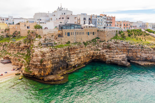Italy, Apulia, Metropolitan City of Bari, Polignano a Mare. Porto di Monopoli. Buildings and wall on the clifs over the sea.