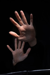 Fototapeta premium Woman showing stop gesture, feeling fear, trying to stop physical abuse, protecting and hiding herself.