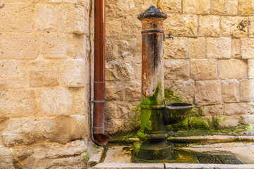 Italy, Apulia, Metropolitan City of Bari, Molfetta. Old and mossy public water spigot.