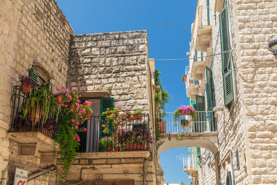Italy, Apulia, Metropolitan City of Bari, Molfetta. Balconies and a small bridge between buildings.