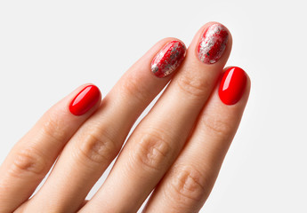 Beautiful manicured woman's hand over white background