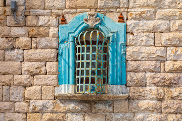 Italy, Apulia, Province of Barletta-Andria-Trani, Trani. Small religious shrine in a stone wall,...