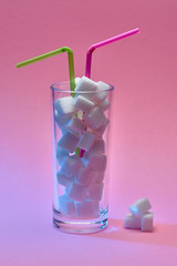 glass with sugar and drinking straw