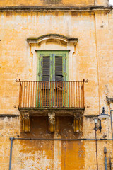 Italy, Basilicata, Province of Matera, Matera. Balcony with green shutters.