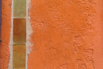 Italy, Basilicata, Province of Matera, Matera. Detail of orange stucco and brick wall.