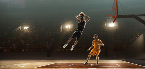 Basketball players fight for a ball near the hoop