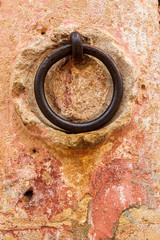 Italy, Basilicata, Province of Matera, Matera. Deatil of an iron ring on a stucco wall.