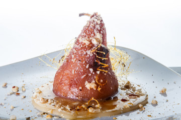 closeup whole pear exclusive decorated with caramel against white