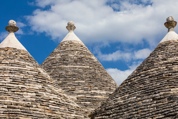 Fototapeta na wymiar Italy, Apulia, Metropolitan City of Bari, Alberobello. Trulli houses -- traditional Apulian stone huts with a conical roof.