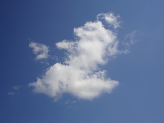 Fluffy White Clouds In Blue Sky Background