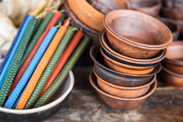 Wax candles and clay bowls on display at the seasonal craft fair.