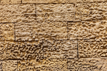 Close-up detail of stucco texture on a stone wall.
