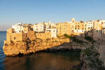 Fototapeta na wymiar Italy, Apulia, Metropolitan City of Bari, Polignano a Mare. View of part of the old town, built on cliffs over the Adriatic Sea.